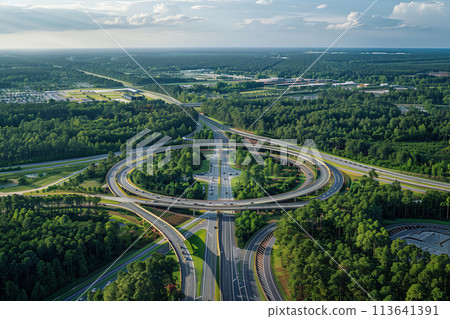 Aerial View of Highway Intersection Surrounded by Trees Aerial View of Highway Intersection Surrounded by Trees 113641391
