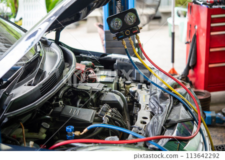 Car refilling air condition at car garage 113642292