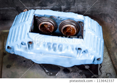 Checking car brake system for repair at car garage 113642337