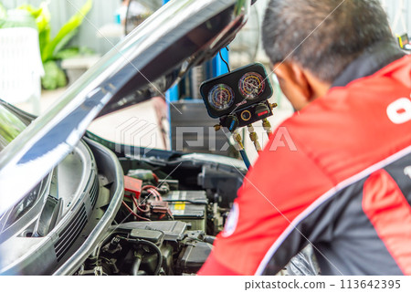 Car refilling air condition at car garage 113642395