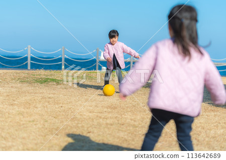 Girls playing soccer outdoors Girls playing soccer outdoors 113642689
