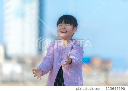 Smiling girl playing in the park Smiling girl playing in the park 113642690