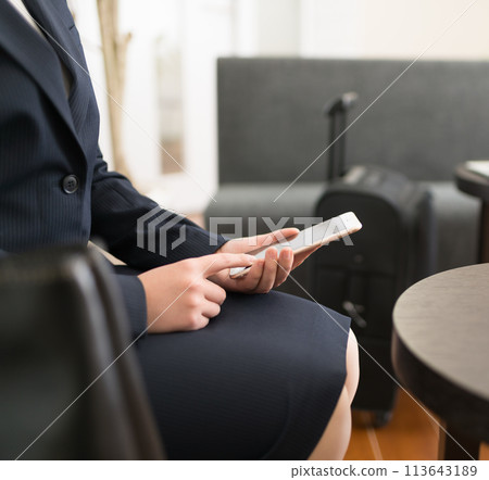 A woman operating a smartphone 113643189