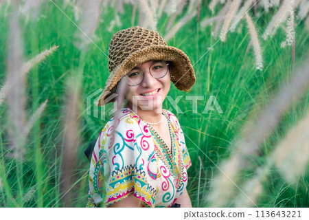 Woman (LGBTQ) posing at flower park garden field 113643221