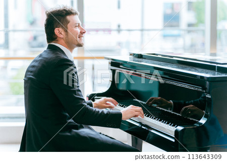 Businessman/pianist playing piano, free piano, and street piano at the station 113643309