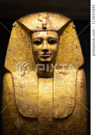 An ancient Egyptian sarcophagus on display, showcasing intricate golden hieroglyphics and craftsmanship. Louvre Museum in Paris, France An ancient Egyptian sarcophagus on display, showcasing intricate golden hieroglyphics and craftsmanship. Louvre Museum in Paris, France 113643885