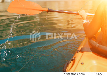 Kayak paddle sea vacation. Person paddles with orange paddle oar on kayak in sea. Leisure active lifestyle recreation activity rest tourism travel 113644220