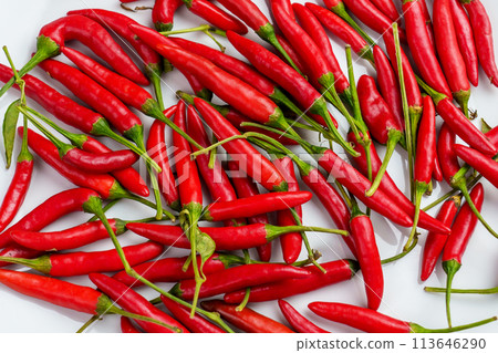 Many fresh red Chili peppers on a white ceramic surface close up. Strong Chilli. Top view 113646290