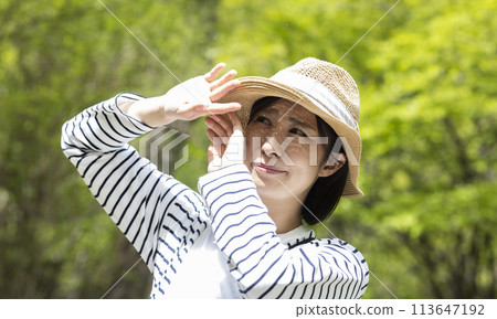 炎熱的夏日陽光和戴草帽的女人 113647192