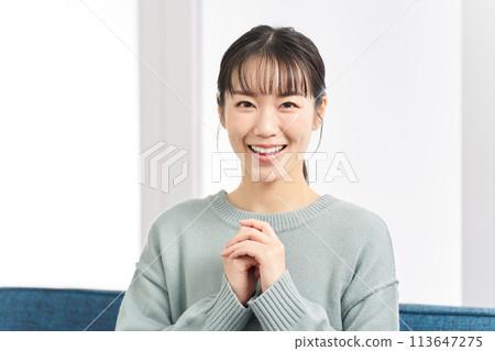 A woman with beautiful teeth is delighted with a surprise A woman with beautiful teeth is delighted with a surprise 113647275