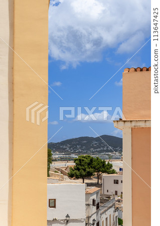 Vertical glimpse into Eivissa Mediterranean architecture under clear blue skies 113647425