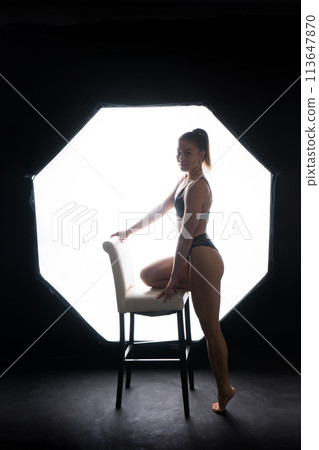 Silhouette of a beautiful young woman wearing underwear in backlight Silhouette of a beautiful young woman wearing underwear in backlight 113647870