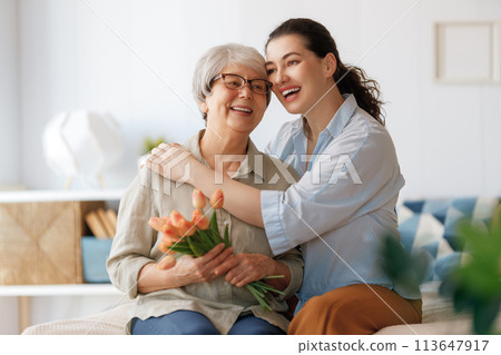 woman and her mother with flowers tulips woman and her mother with flowers tulips 113647917