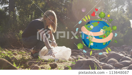 Image of hugging globe over happy caucasian woman picking up rubbish in countryside Image of hugging globe over happy caucasian woman picking up rubbish in countryside 113648087