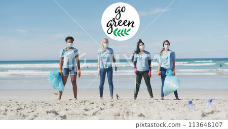 Image of go green text and logo over happy diverse group wearing face masks cleaning up beach 113648107