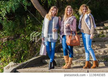 Three fashionable models outdoor 113648385