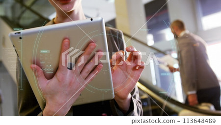 Young Caucasian woman interacts with a futuristic interface, with copy space 113648489