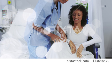 Image of spots over african american female nurse with patient 113648579
