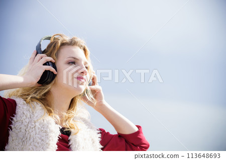 Woman wearing headphones outdoor Woman wearing headphones outdoor 113648693