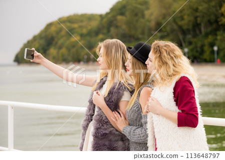 Three women taking selfie outdoor Three women taking selfie outdoor 113648797