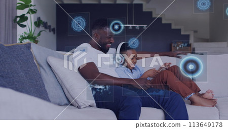 Image of diverse data over happy african american father and son using tablet Image of diverse data over happy african american father and son using tablet 113649178