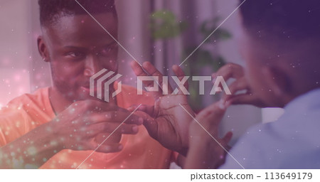 Image of lights over happy african american father and son playing finger games Image of lights over happy african american father and son playing finger games 113649179