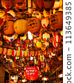 Lanterns floating in the city at night 113649385