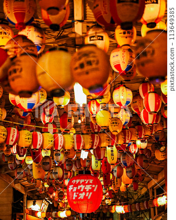 Lanterns floating in the city at night 113649385