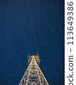 Radio tower shining in the night sky 113649386