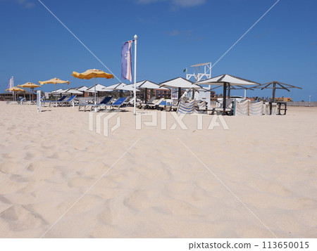 Umbrellas on the beach at Atlantic Ocean at Sal island in Cape Verde Umbrellas on the beach at Atlantic Ocean at Sal island in Cape Verde 113650015