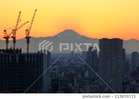 Sunset behind Mt. Fuji as seen from Minato-ku in central Tokyo Japan Sunset behind Mt. Fuji as seen from Minato-ku in central Tokyo Japan 113650115