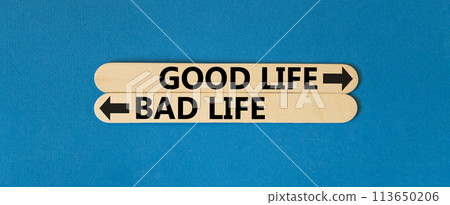 Good or bad life symbol. Concept word Good life Bad life on beautiful wooden stick. Beautiful blue table blue background. Business and Good or bad life concept. Copy space. Good or bad life symbol. Concept word Good life Bad life on beautiful wooden stick. Beautiful blue table blue background. Business and Good or bad life concept. Copy space. 113650206