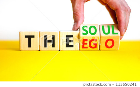 Soul or ego symbol. Concept word The soul or The ego on beautiful wooden cubes. Beautiful yellow table white background. Psychologist hand. Psychological soul or ego concept. Copy space. 113650241