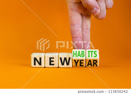 New year and habits symbol. Concept word New year New habits on wooden cubes. Beautiful orange table orange background. Psychologist hand. Psychological new year and habits concept. Copy space. 113650242
