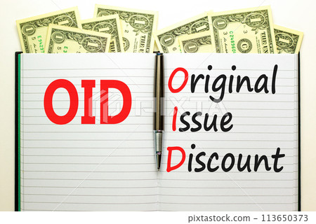 OID original issue discount symbol. Concept words OID original issue discount on beautiful white note. Beautiful dollar bills background. Business OID original issue discount concept. Copy space. OID original issue discount symbol. Concept words OID original issue discount on beautiful white note. Beautiful dollar bills background. Business OID original issue discount concept. Copy space. 113650373