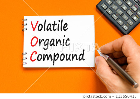 VOC volatile organic compound symbol. Concept words VOC volatile organic compound on beautiful white note. Beautiful orange background. Business VOC volatile organic compound concept. Copy space. 113650413