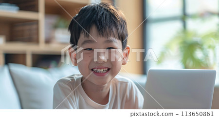 Cute little Asian boy using laptop at home. Training concept. 113650861