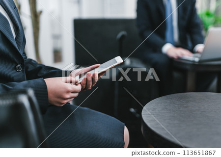 A woman operating a smartphone A woman operating a smartphone 113651867