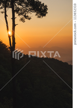 nature traveling with orange sky and layer of mountain with sunrise background 113652310
