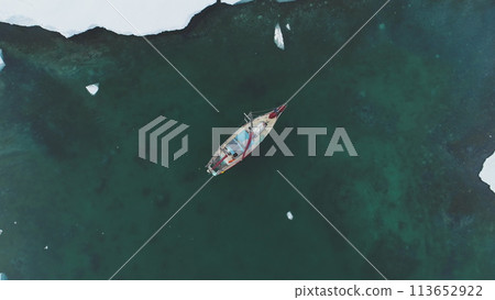 Yacht Sail in Arctic Ocean Aerial Top Down View. Sailing Vessel Explore Polar Nature Chrystal Clear Water for Global Warming Effect Above Drone View 113652922