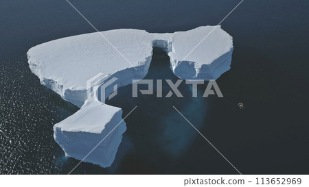 Aerial Overview Of Iceberg Among Antarctica Ocean. Drone Flight Over Huge Ice Mountain. Sunlit Cold Ocean Water. Winter Antarctic Landscape. Wilderness. Virgin Nature. Aerial Overview Of Iceberg Among Antarctica Ocean. Drone Flight Over Huge Ice Mountain. Sunlit Cold Ocean Water. Winter Antarctic Landscape. Wilderness. Virgin Nature. 113652969