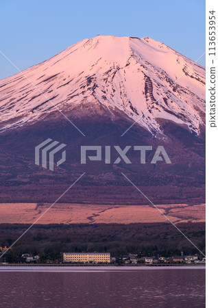 Mount Fuji at sunrise as seen from Lake Yamanaka, Yamanashi Prefecture (Red Fuji) 113653954