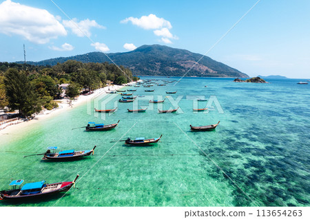 Aerial view of longtail boat and beach at Koh Lipe. Aerial view of longtail boat and beach at Koh Lipe. 113654263