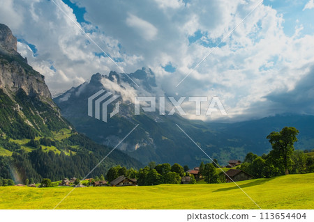 View on the alpine valley Grindelwald. Jungfrau, Switzerland. Under the Bernese alps. Mountain village. View on the alpine valley Grindelwald. Jungfrau, Switzerland. Under the Bernese alps. Mountain village. 113654404