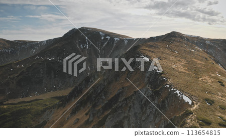 Mountain ridges at autumn aerial. Nobody nature landscape. Mountaineering vacation. Mount ranges at burned grass and moss. Cinematic tourism, travel scenery at drone shot. Carpathians, Ukraine, Europe 113654815