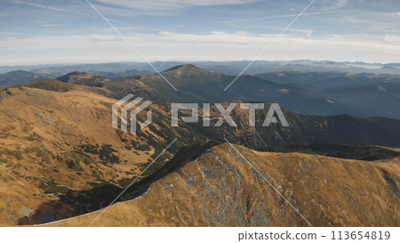 Closeup mountain ridges aerial. Nobody wild nature landscape. Brown peaks with burnt grass. Mountaineering travel scenery. Cinematic Carpathians mount ranges, Ukraine, Europe. Tourism concept 113654819