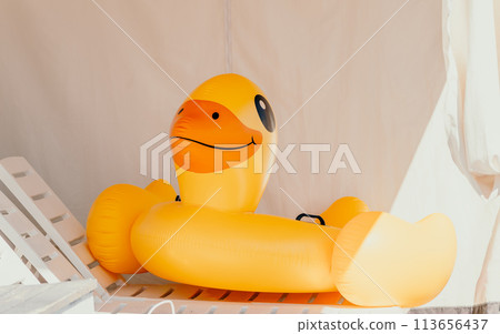 Inflatable duckling, summer - Bright yellow floatation device enhances swimming experience and safety ensured for young swimmers on warm summer days. Inflatable duckling, summer - Bright yellow floatation device enhances swimming experience and safety ensured for young swimmers on warm summer days. 113656437