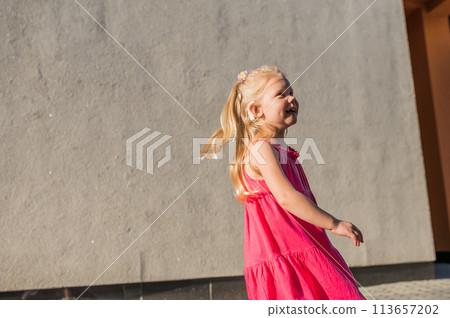 Child girl with hearing aids and cochlear implants having fun outdoor speak and playing. Copy space and empty place for advertising. Inclusion Child girl with hearing aids and cochlear implants having fun outdoor speak and playing. Copy space and empty place for advertising. Inclusion 113657202
