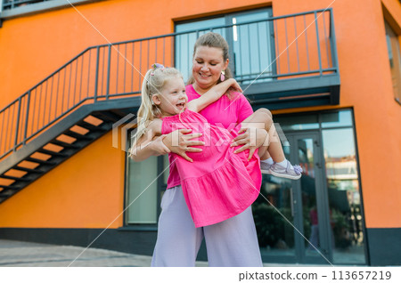 Deaf child with cochlear implant for hearing audio and aid for impairment having fun and laughs with mother outdoor in summer. Sound fitting device to help with communication listening and interaction Deaf child with cochlear implant for hearing audio and aid for impairment having fun and laughs with mother outdoor in summer. Sound fitting device to help with communication listening and interaction 113657219