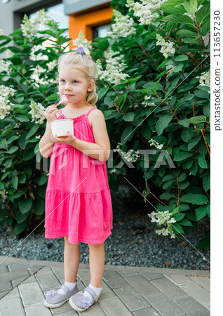 Funny child with cochlear implant walks outdoor. Hearing aid and medicine innovating technology concept. Diversity and inclusion. 113657230